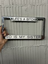 Vintage Chrome License Plate Frame Life’s A Bitch So Is My Sister  picture