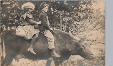 GIRL RIDING OX spunky costume real photo postcard rppc wild kids ~unusual silly picture