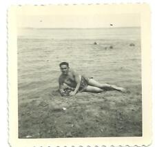 photo bare chest young handsome guy posing lying on beach swim trunks sexy gay picture
