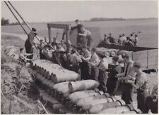 PHOTOGRAPH - ARMOURERS LIFTING A BOMB FROM A LORRY - RAF LINTON ON OUSE - 1943 picture