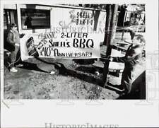1992 Press Photo Bee Watts & Chris Coble hang banner for Shell's BBQ anniversary picture