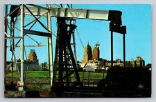 Skyline of Oklahoma city,Oklahoma seen thru Downtown Oil Derrick  VTG Postcard picture
