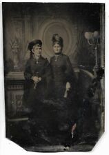 Tintype Photo  2 women wearing hat and holding objects  As-IS picture