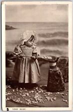 Very Busy Cute Little Girl Busy Playing Stones In The Ocean Postcard picture