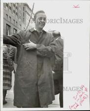 1967 Press Photo Henry Veit shows blasted raincoat from explosion at store. picture