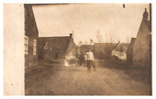 postcard Man walks his dog down the street RPPC A0900 picture