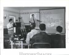1990 Press Photo Officials watching slides in Chambers County, Texas - hca10305 picture