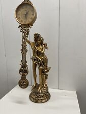 swinging statue clock with musician picture