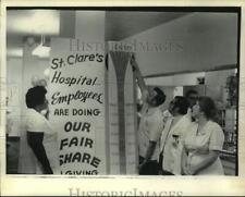 1972 Press Photo St. Clare's Hospital staff check fundraising progress, New York picture
