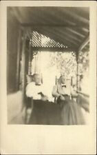 RPPC Two old ladies on porch in rocking chairs ~ 1907-1914 real photo postcard picture