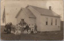 1909 Real Photo RPPC Postcard SCHOOL HOUSE with Students and Adults / U.S. Flag picture