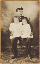RPPC-Man holding two babies on his lap -  picture
