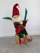 CHRISTMAS ANIMATED SANTA’S ELF SITTING ON A GIFT.  COMMERCIAL DISPLAY . picture