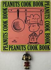Vintage U.F.S. Metal PEANUTS LUCY Pendant/ Keychain & 1970 Cook book Schulz picture