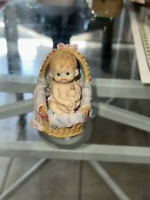 Vintage Ceramic Baby Figurine In A Ceramic Basket picture