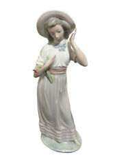 Nao Lladro Figurine. Elegant Lady Wearing a Stylish Floral Hat picture