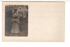 RPPC Postcard: Dressed up woman with parasol in front of home - exterior picture