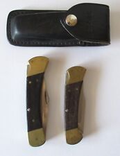 Pair of Buck Folding Knives 110 and 112 w/ Sheath for 110 picture