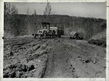 Press Photo Army road patrol grader tows Canadian civilian truck trough the mud picture