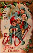 Christmas Children Sled Sledding Blow Horn Holly Frame Snow c1910s postcard AQ1 picture