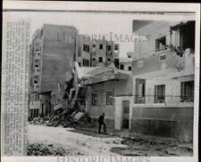 1970 Press Photo Man walks by destroyed houses after Israeli bombings in Egypt picture
