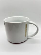 Starbucks 2012 White Coffee Mug, Gold Letters Red Trim Around Bottom 16 oz. picture