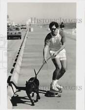 1986 Press Photo Tank pulls Robert Malmstrom on skateboard at Galveston Seawall. picture