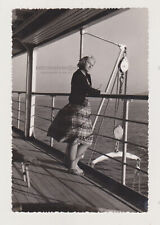 Beautiful Young Woman on Deck Lost in Contemplation Amidst the Sea's Embrace picture