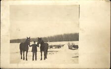 RPPC Man holding farm horses ~ farm sleds and wagons ~ vintage photo postcard picture