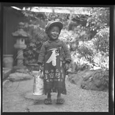 Toddler with classic apron posing for a photo, 1930s picture