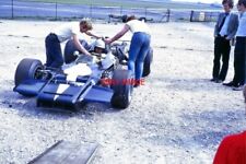 PHOTO  FRANK GARDNER AND LOLA T190 CHEVROLET. THRUXTON AUGUST 1970. FRANK IS BEI picture