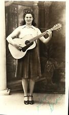 Young woman playing G-chord on old Kay guitar; nice 1910s RPPC picture