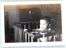 Vintage Photo 1940s, Toddler peaking over antique crib, Dressed cute, 4.5x3.5 picture