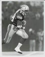 1987 Press Photo Seattle Seahawks running back #28 Curt Warner holding the ball picture
