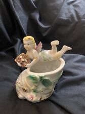 Antique porcelain angel holding a knight's shield. Candle holder. picture