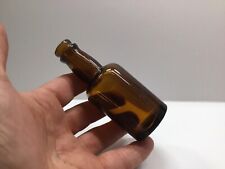 Small Squatty Antique Amber Sample Size Liquor Bottle. picture