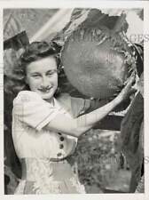 1943 Press Photo Peggy Hanna poses with an enormous sunflower in Chicago IL picture