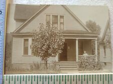Postcard Beautiful Home with a Woman by the Porch picture