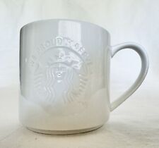 STARBUCKS 2012 We Proudly Serve 12 Oz Coffee Mug White Embossed 3D Siren Logo picture