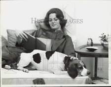 1960 Press Photo Woman and her dog relax together while she reads - nei44999 picture