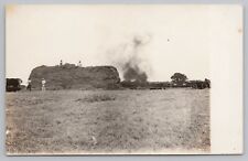 RPPC Group of People in Field Burning c1920 Real Photo Postcard picture