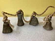 four small antique bronze bells. picture