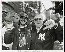 1986 Press Photo Red Sox fan and Yankee fan give hand gestures prior to game picture