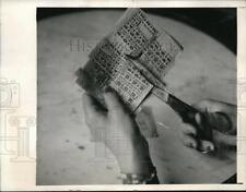 1945 Media Photo Madame Georgette clips coupons from the official ration bank picture