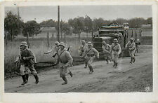 WWII Postcard German Soldiers Run down Road in Front Of Transport Truck picture