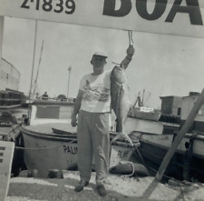 Man Holding Big Fish On Dock Near Boats B&W Photograph 3.5 x 3.5 picture