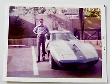 PICTURE OF A HAPPY YOUNG MAN WITH A CORVETTE picture