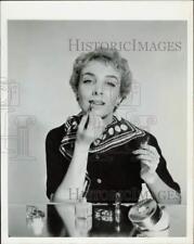 1954 Press Photo Model uses a brush to apply lipstick - nei06891 picture