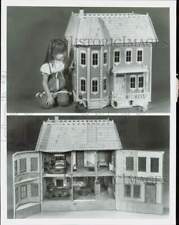 1988 Press Photo Little girl admiring a dollhouse - lra97029 picture