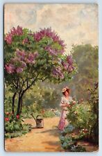 Postcard - Woman in a Garden of Roses and Flowering Trees with Watering Can picture